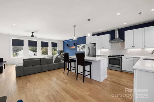 a living room with furniture and kitchen view