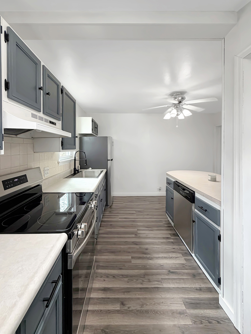 1534 West Fairview Road Freeport, IL 61032 - Photo 12 of 30 a kitchen with kitchen island a sink stove and refrigerator