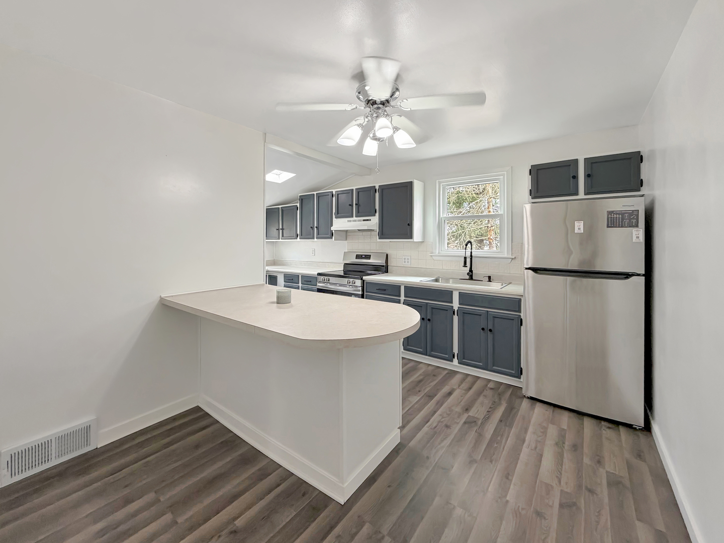 1534 West Fairview Road Freeport, IL 61032 - Photo 10 of 30 a kitchen with a sink stainless steel appliances and wooden floor