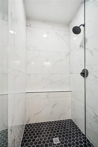 a bedroom with a large bed a chandelier and a window