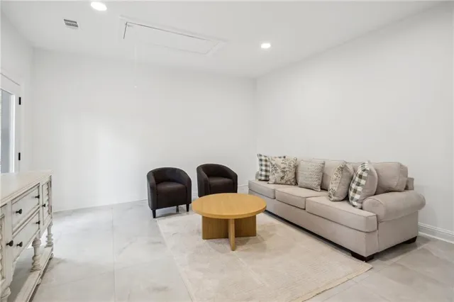 a view of a patio with table and chairs and wooden floor