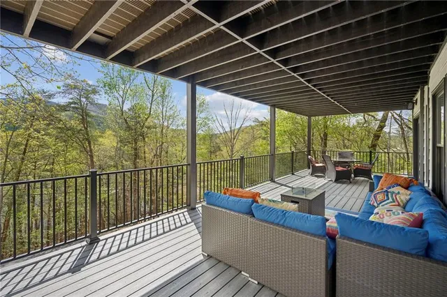 a living room with stainless steel appliances kitchen island granite countertop a sink and a refrigerator
