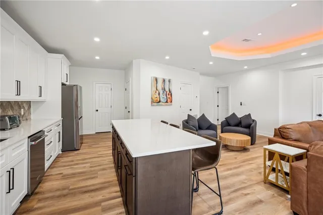 a spacious bedroom with a bed and glass window