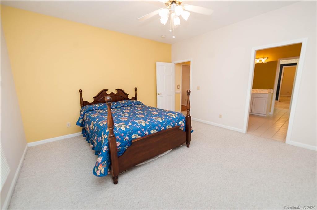 280 Earles Fort Road Landrum, SC 29356 - Photo 22 of 39 a bed sitting in a bedroom next to a bathroom
