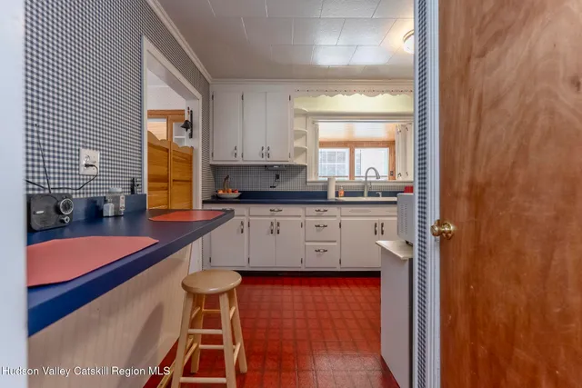 a kitchen with granite countertop kitchen island stainless steel appliances a sink and a window