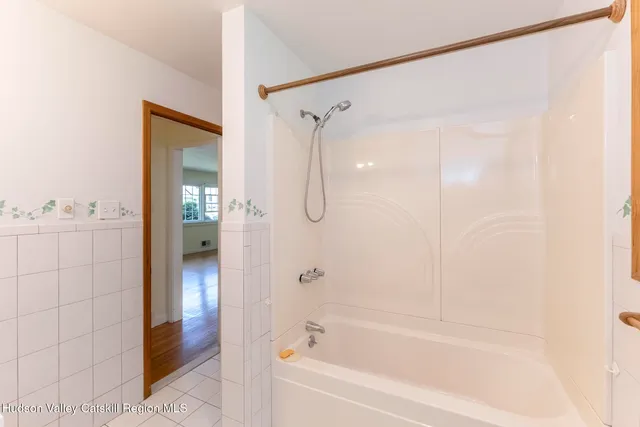 a bathroom with a shower and a bath tub