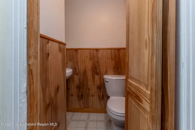 a bathroom with a toilet and a shower curtain