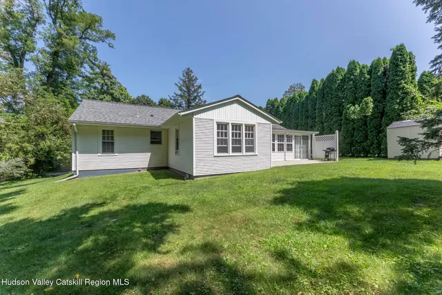 a view of a house with yard and tree s