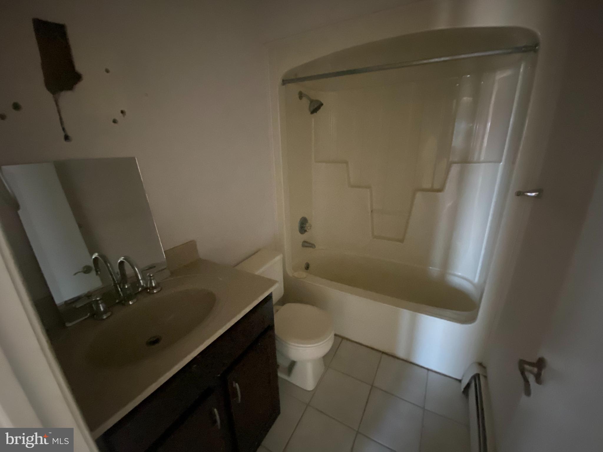 427 Smith Street, Unit 2R Dunmore, PA 18512 - Photo 6 of 7 a bathroom with a sink a toilet and shower
