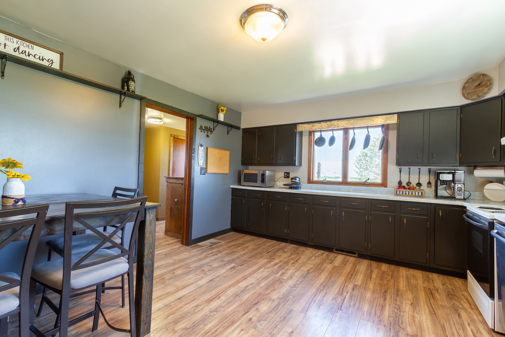 4783 Cherry Valley Road Kirkland, IL 60146 - Photo 11 of 41 a kitchen with granite countertop wooden floors and wooden cabinets