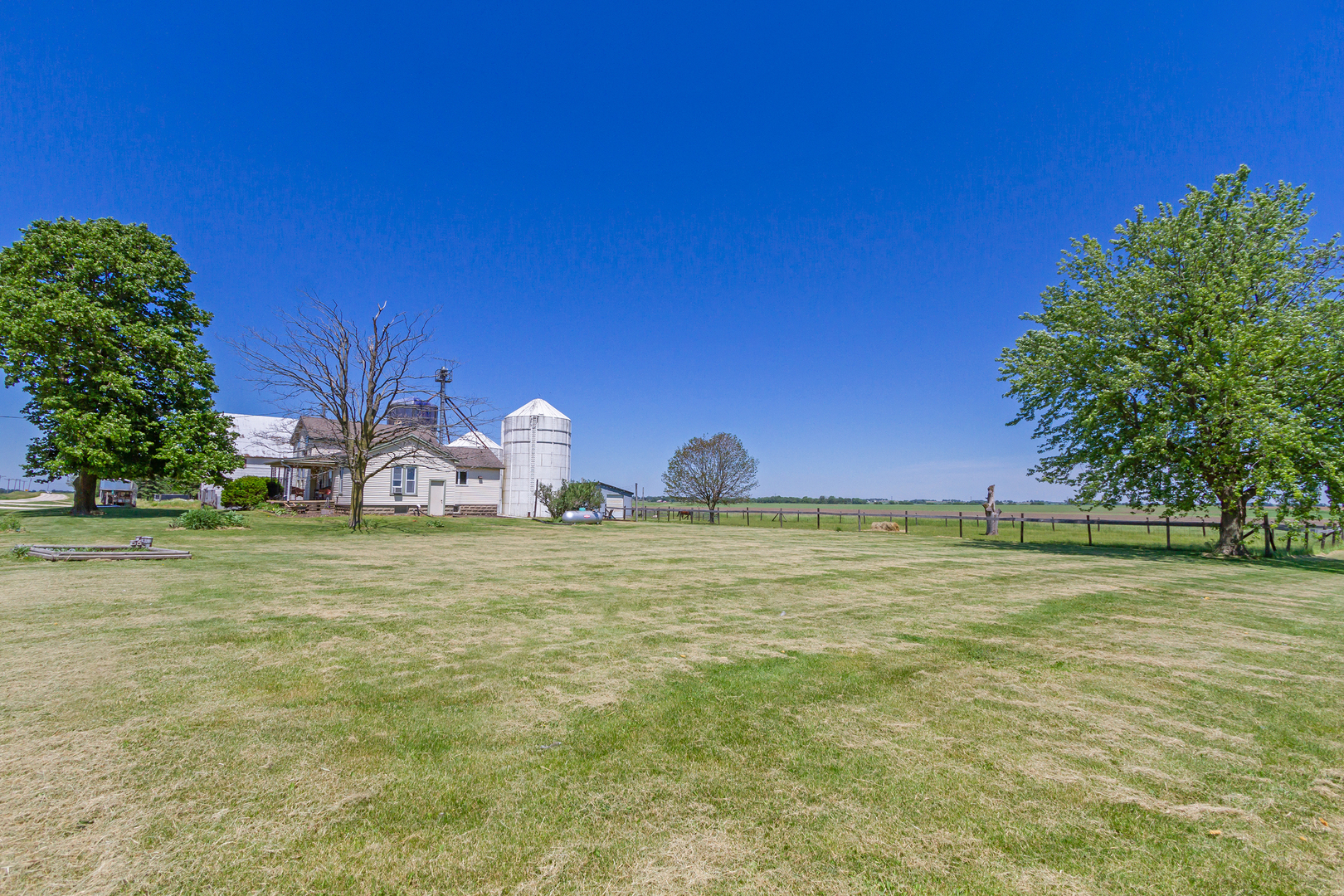 4783 Cherry Valley Road Kirkland, IL 60146 - Photo 20 of 41 a front view of a house with a yard and garage