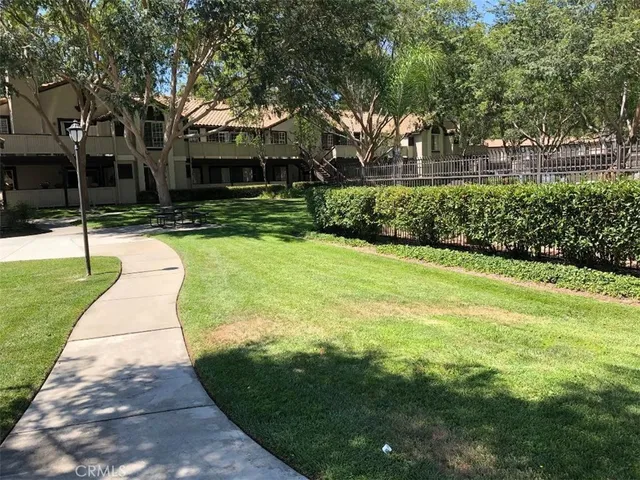 a view of yard with swimming pool and green space