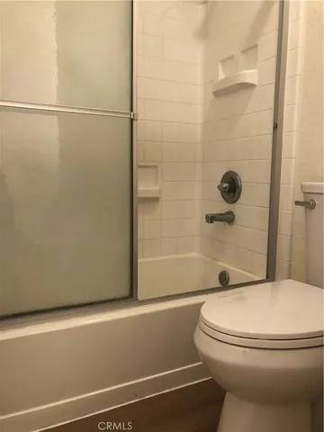 a bathroom with a toilet and a shower