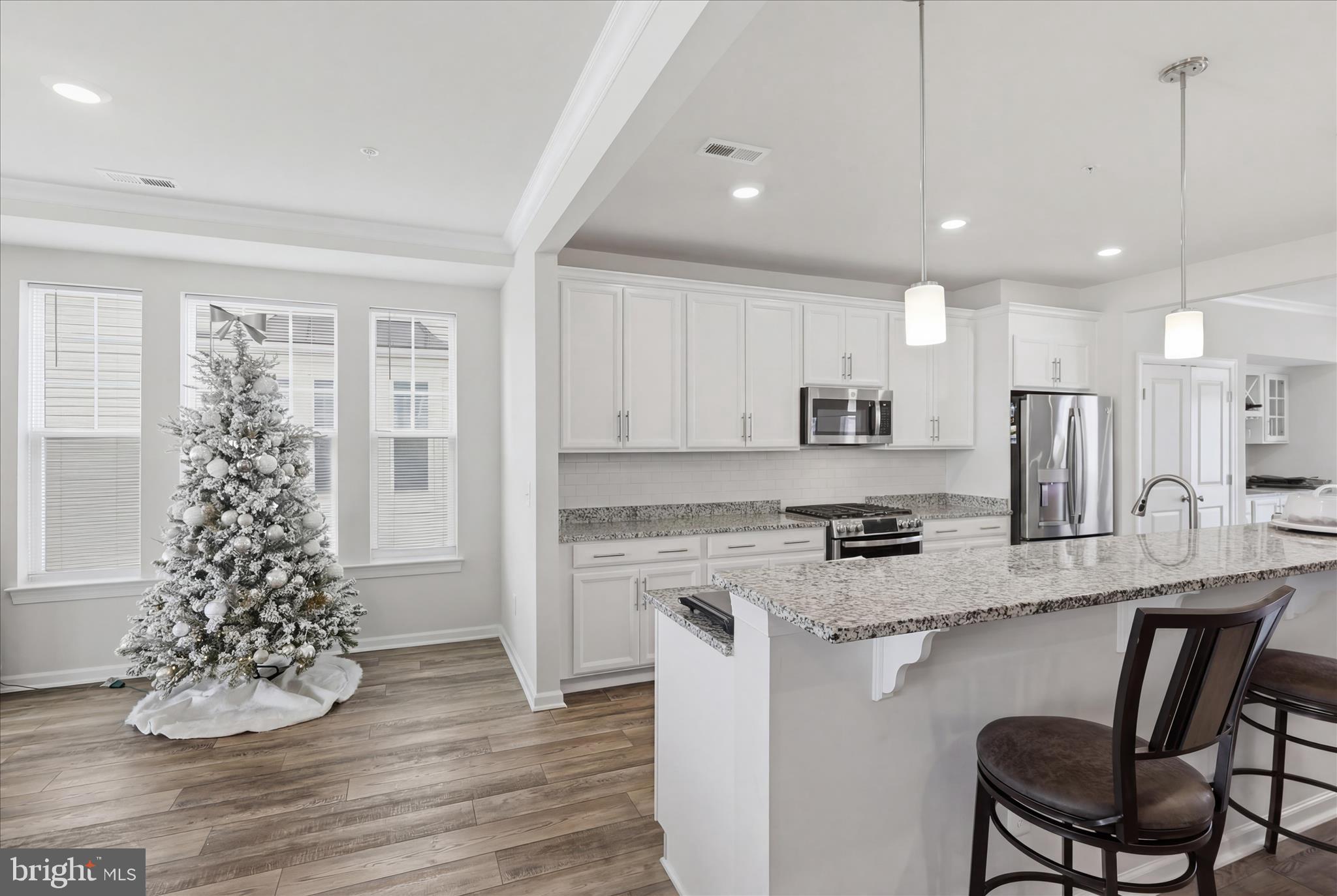 4932 MacDonough Place Frederick, MD 21703 - Photo 16 of 70 a kitchen with granite countertop a stove a sink a refrigerator and wooden floor