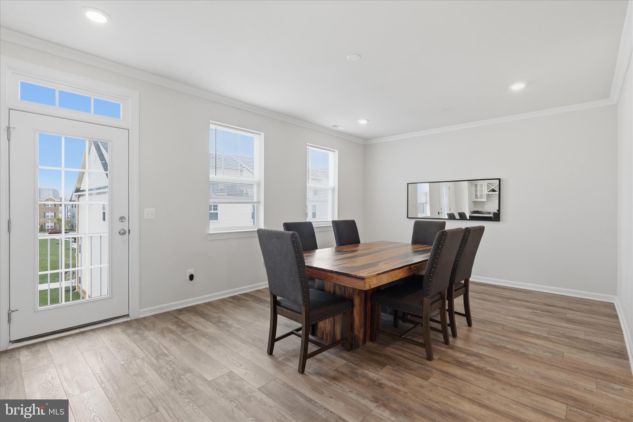 4932 MacDonough Place Frederick, MD 21703 - Photo 26 of 70 a view of a dining room with furniture window and wooden floor