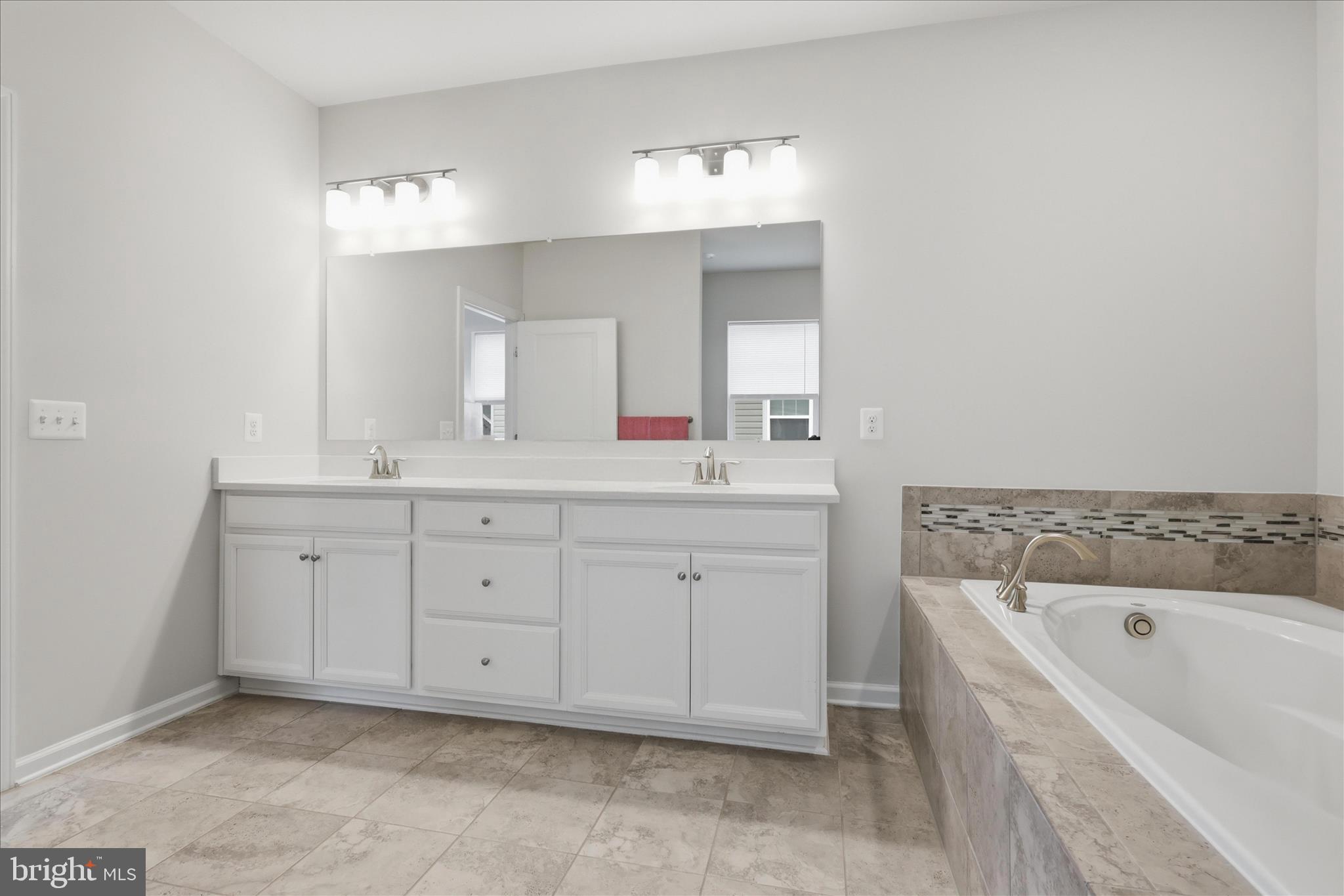 4932 MacDonough Place Frederick, MD 21703 - Photo 43 of 70 a spacious bathroom with a tub sink and mirror