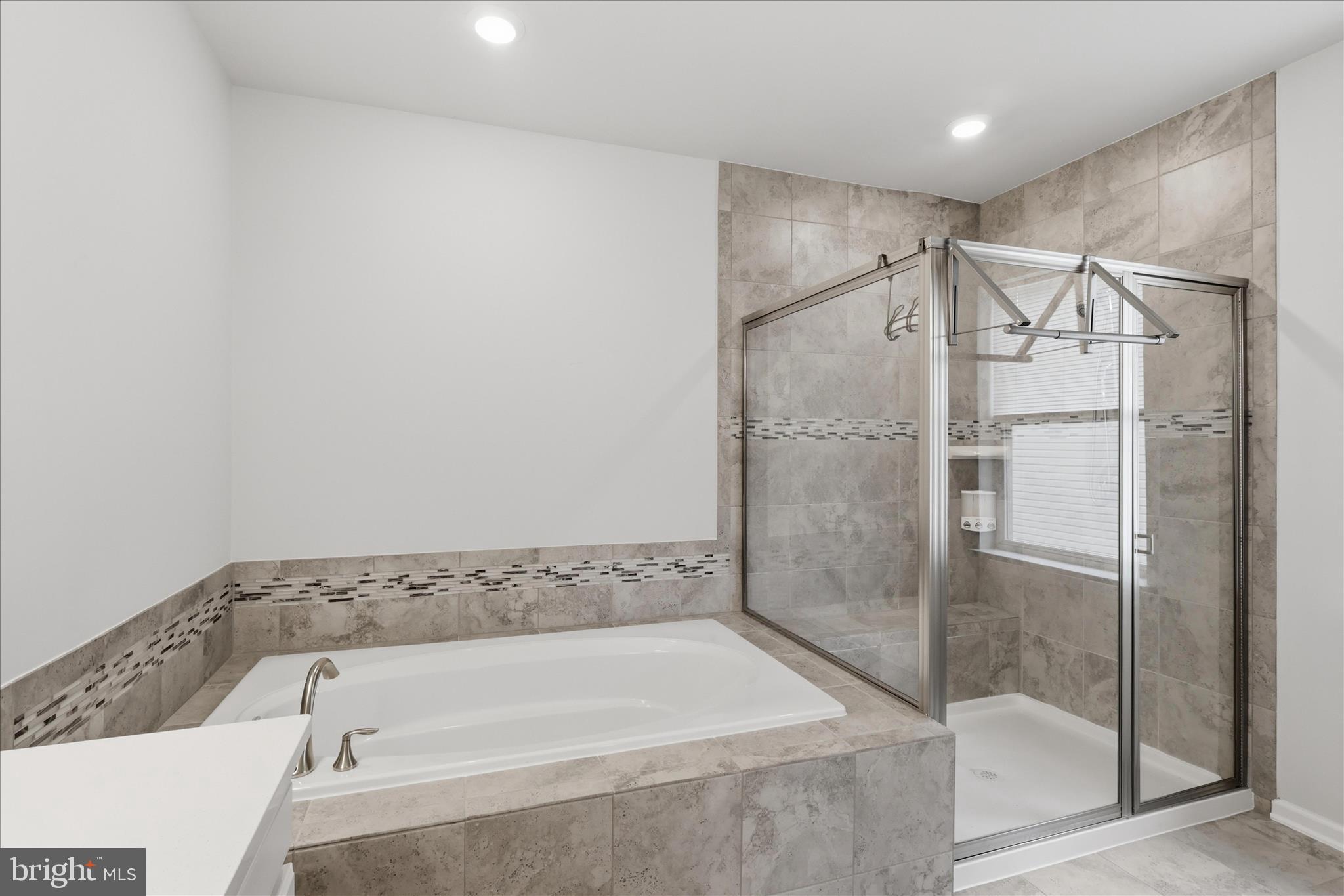 4932 MacDonough Place Frederick, MD 21703 - Photo 45 of 70 a bathroom with a bathtub and a shower
