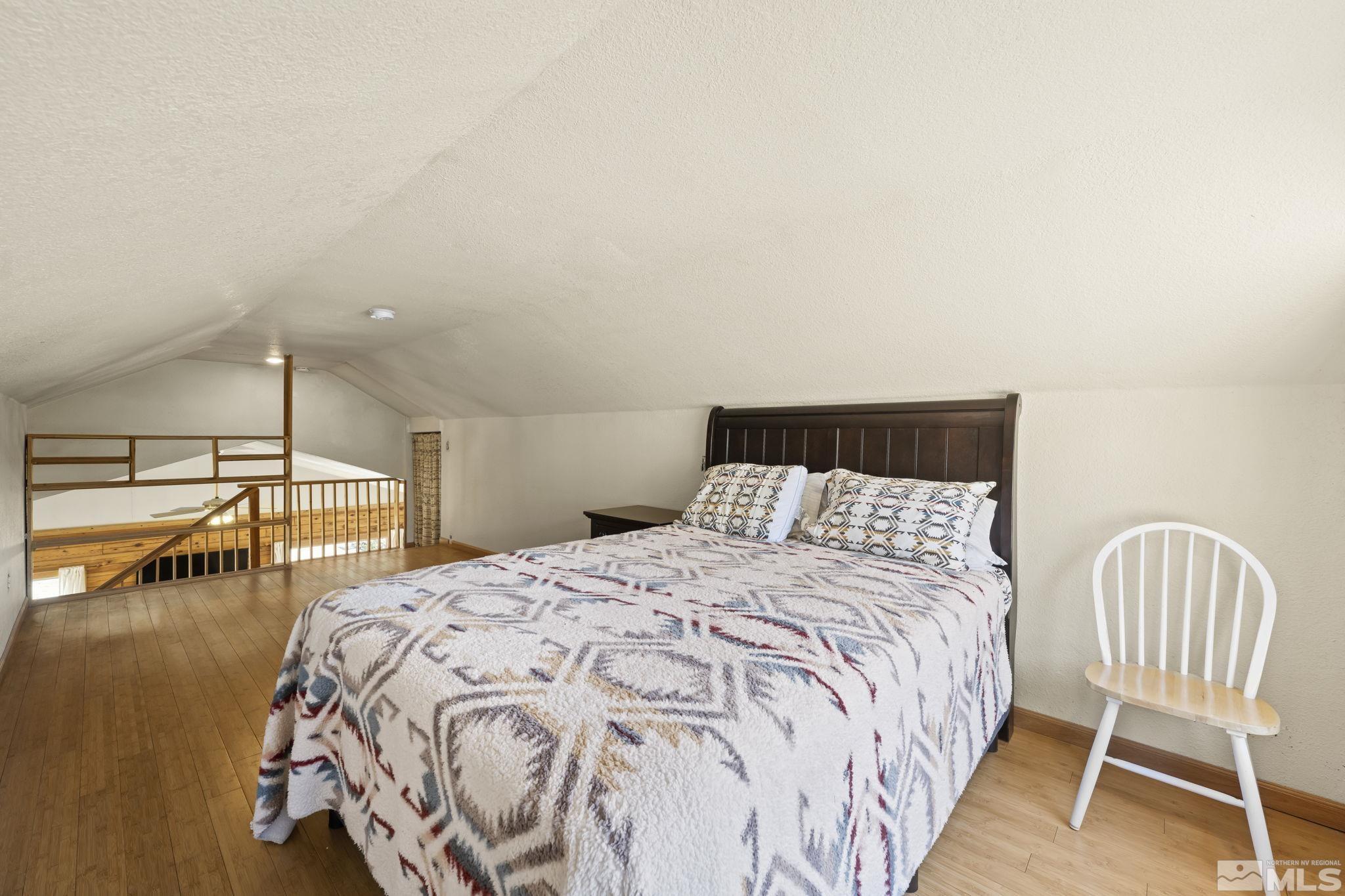 2200 Lousetown Road Reno, NV 89521 - Photo 12 of 40 a bedroom with a bed and a chair