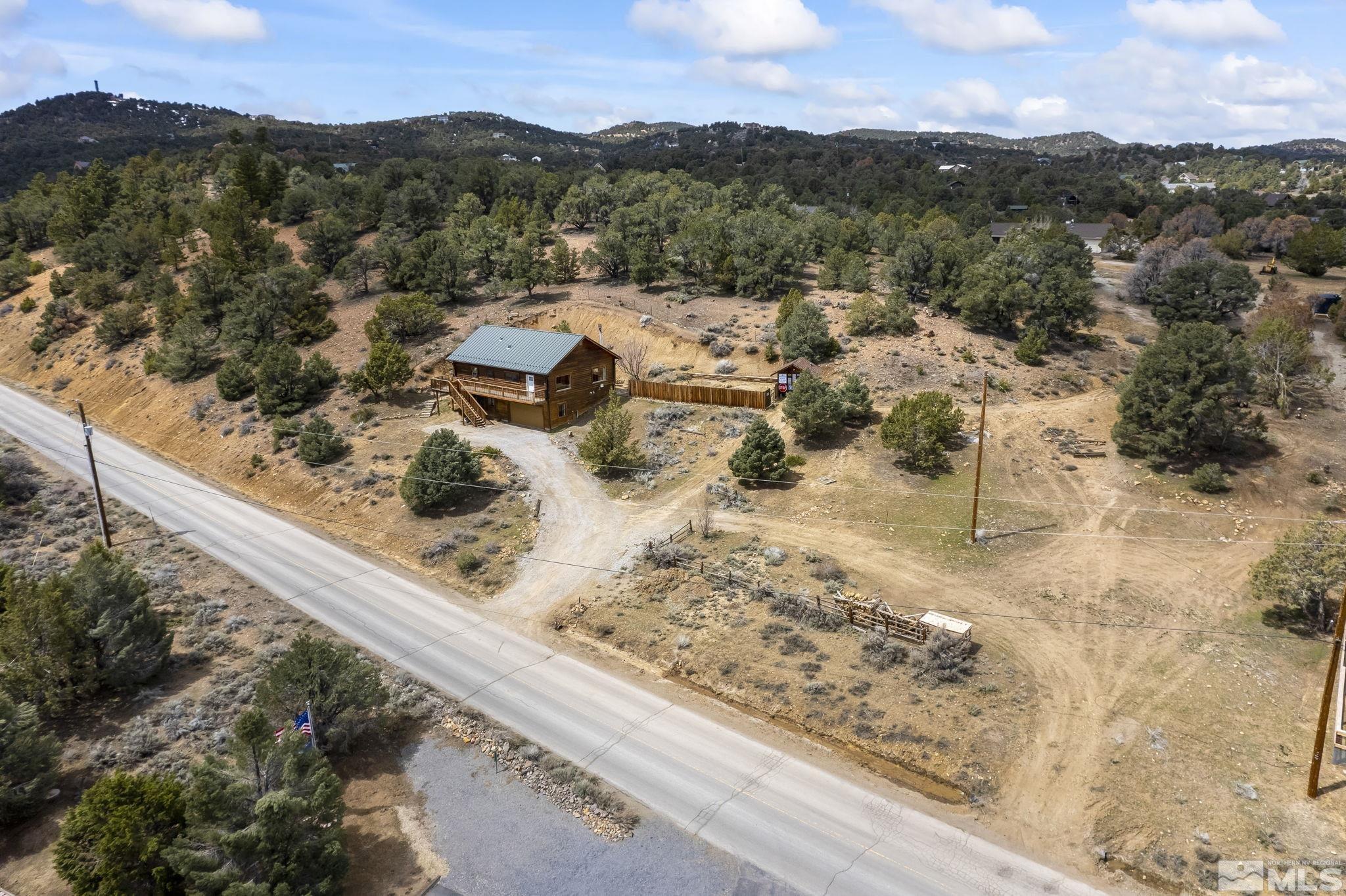 2200 Lousetown Road Reno, NV 89521 - Photo 24 of 40 a view of a backyard with wooden floor and a mountain view