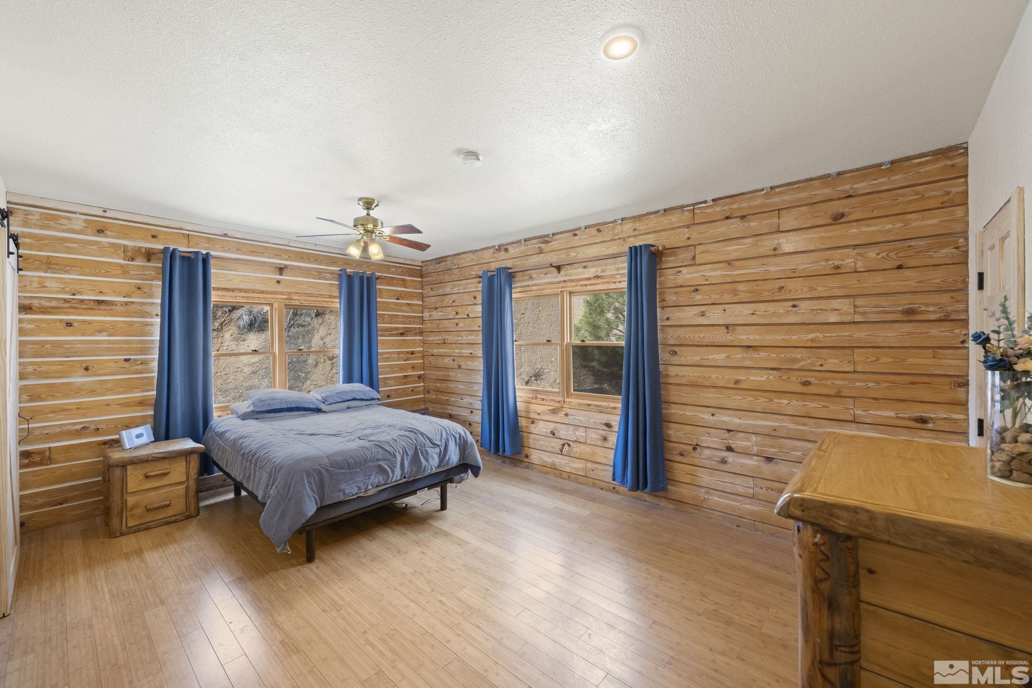 2200 Lousetown Road Reno, NV 89521 - Photo 7 of 40 a bedroom with a bed and large windows
