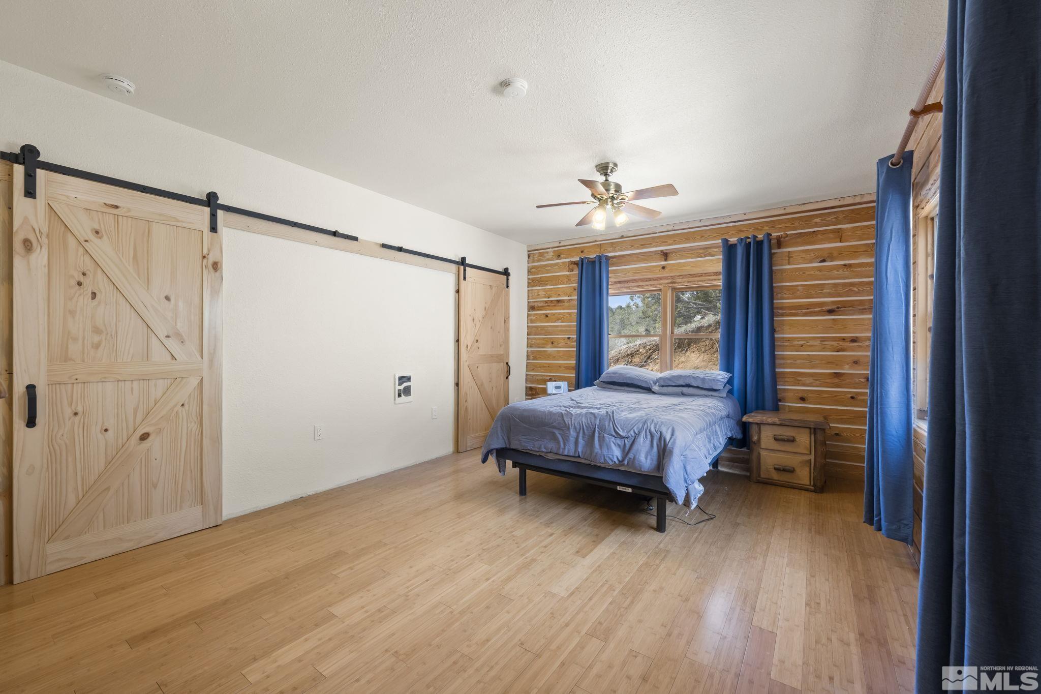 2200 Lousetown Road Reno, NV 89521 - Photo 10 of 40 a bedroom with a bed and a chandelier