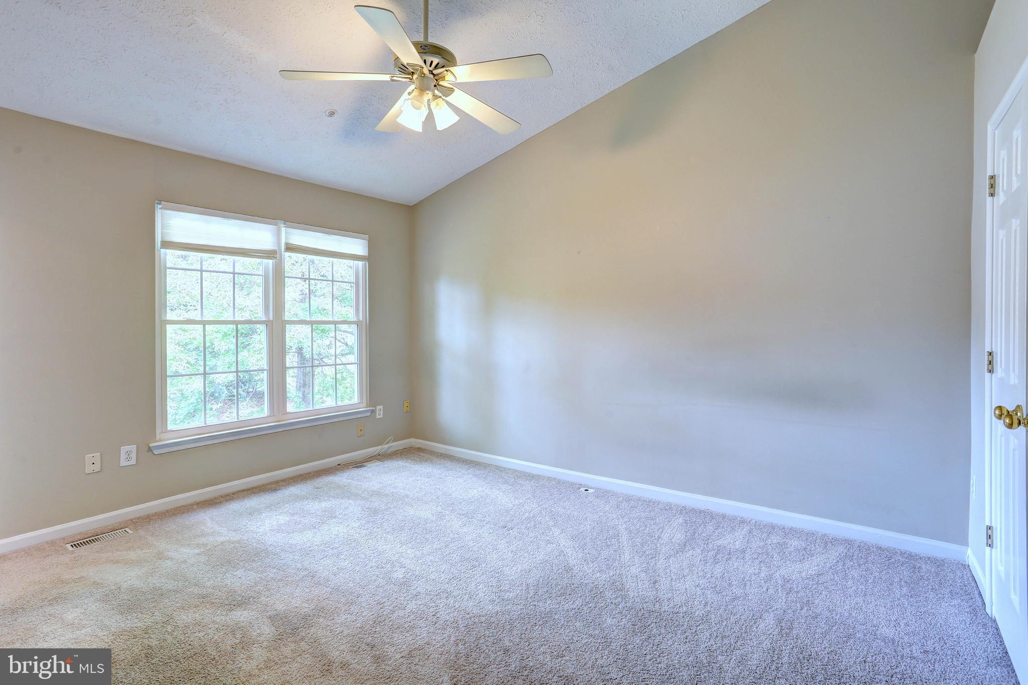 6136 Starburn Path Columbia, MD 21045 - Photo 11 of 35 an empty room with a window and a fan