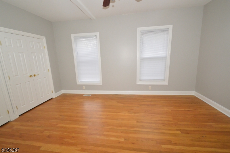 139 Forest Street, Unit 1 Montclair, NJ 07042 - Photo 13 of 23 an empty room with wooden floor and windows