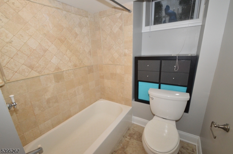 139 Forest Street, Unit 1 Montclair, NJ 07042 - Photo 18 of 23 a white toilet sitting next to a white sink and vanity