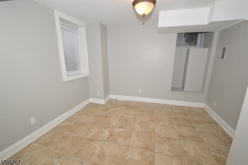 139 Forest Street, Unit 1 Montclair, NJ 07042 - Photo 19 of 23 an empty room with windows