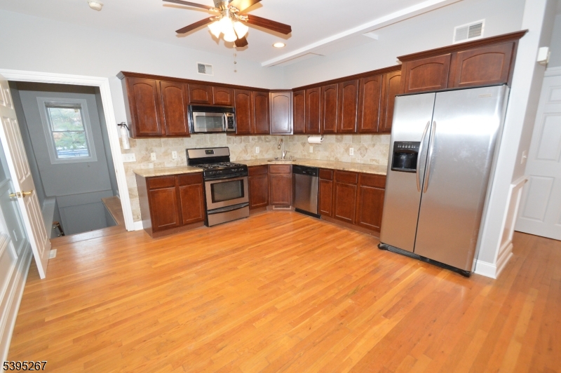 139 Forest Street, Unit 1 Montclair, NJ 07042 - Photo 5 of 23 a kitchen with stainless steel appliances granite countertop a refrigerator a stove top oven a sink and dishwasher
