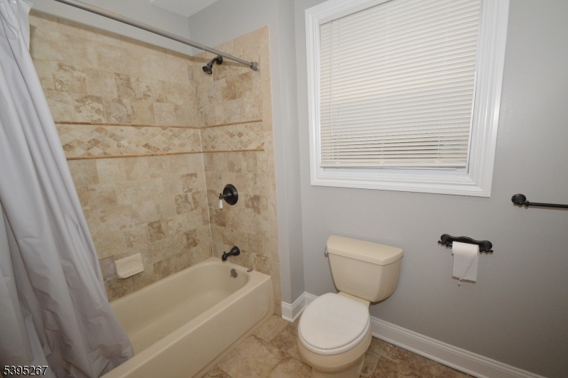 139 Forest Street, Unit 1 Montclair, NJ 07042 - Photo 10 of 23 a bathroom with a toilet a bath tub and a shower