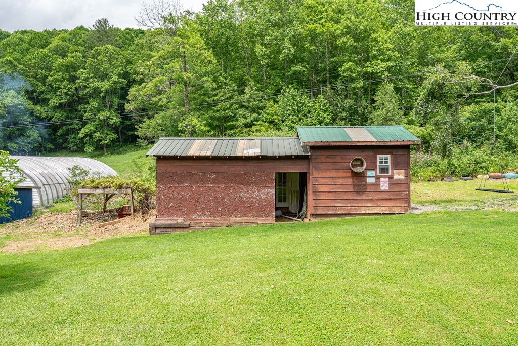 285 Roaring Fork Road Todd, NC 28684 - Photo 37 of 41 a front view of a house with garden