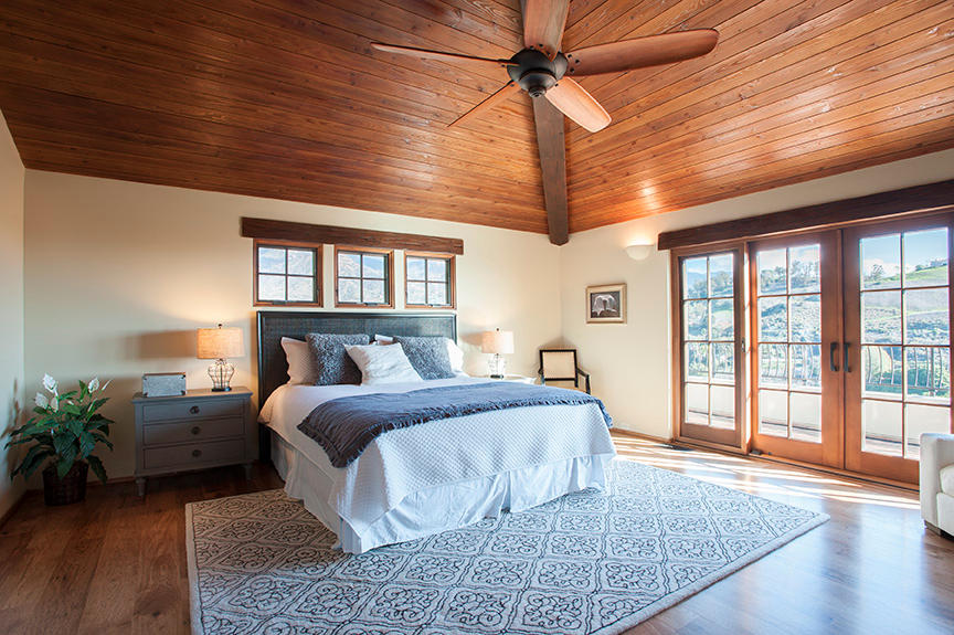 20 Alisal Road Santa Barbara, CA 93103 - Photo 13 of 32 a spacious bedroom with a large bed and a chandelier