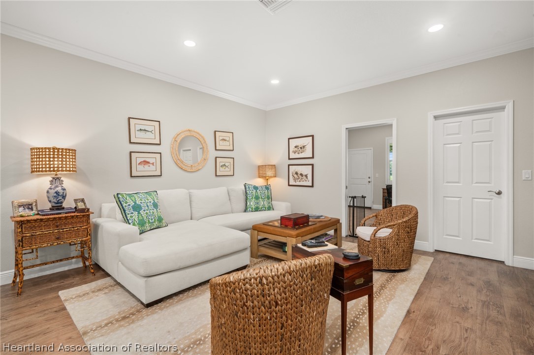 4734 Haw Branch Road, Unit 110 Sebring, FL 33875 - Photo 2 of 50 a living room with furniture and wooden floor