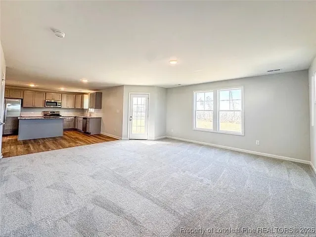 an empty room with furniture and windows
