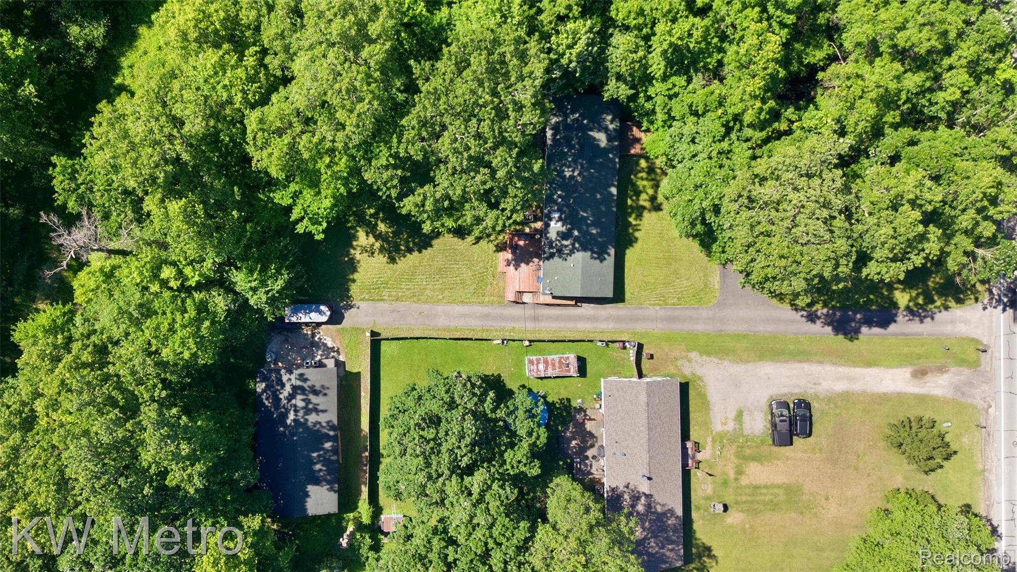 22733 Sumpter Road Belleville, MI 48111 - Photo 41 of 52 Aerial perspective showcasing multiple structures surrounded by mature trees