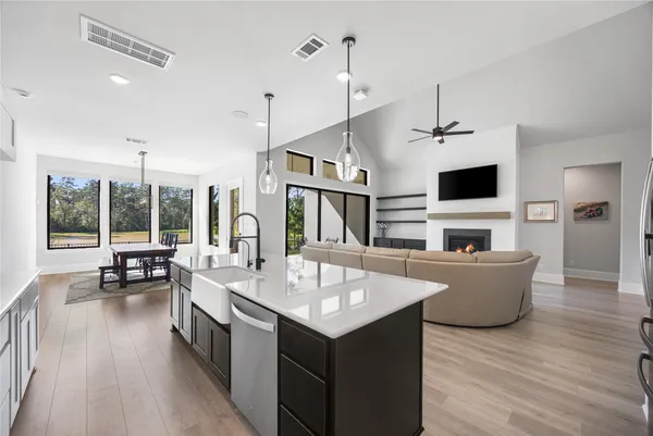 a bathroom with a tub sink double vanity and mirror