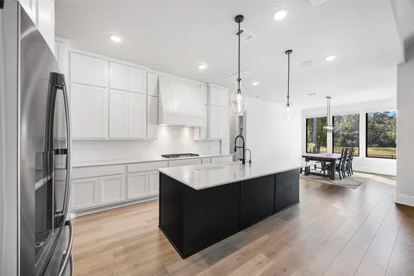 a view of a hallway with wooden floor and furniture