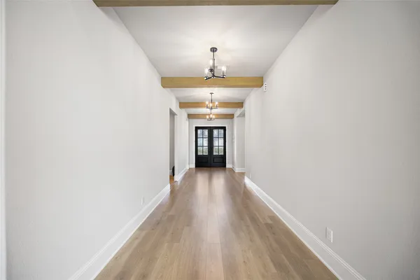 a large kitchen with stainless steel appliances kitchen island granite countertop a refrigerator and a sink