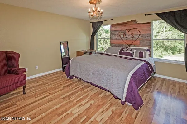 a bed sitting in a bedroom next to a window