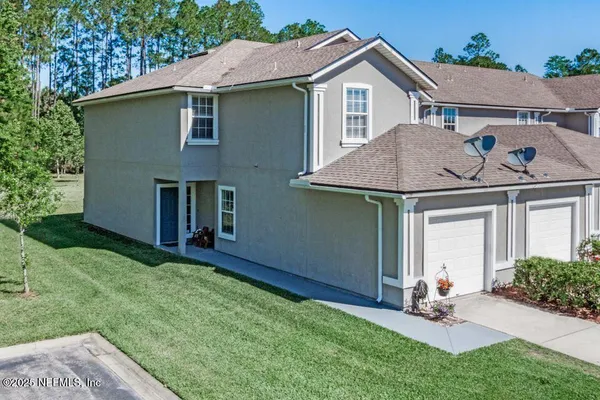 a view of a house with a yard and plants