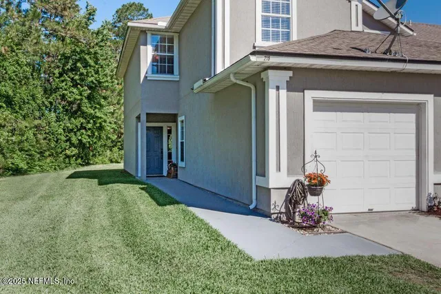 a view of a house with backyard porch and sitting area