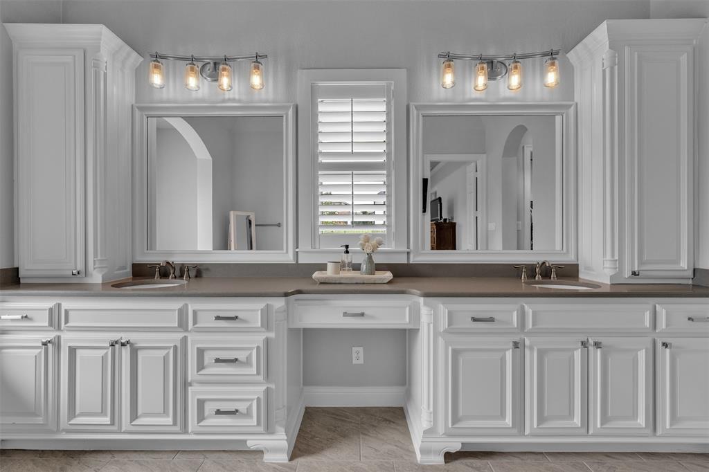 1060 Waters Edge Court Oak Point, TX 75068 - Photo 27 of 40 a bathroom with granite countertop white cabinets and a sink
