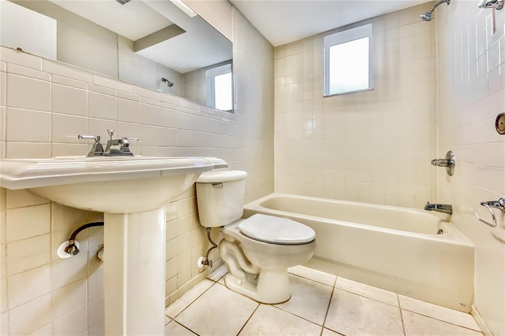 4153 Woodtrail Boulevard New Port Richey, FL 34653 - Photo 11 of 16 a bathroom with a sink toilet and shower