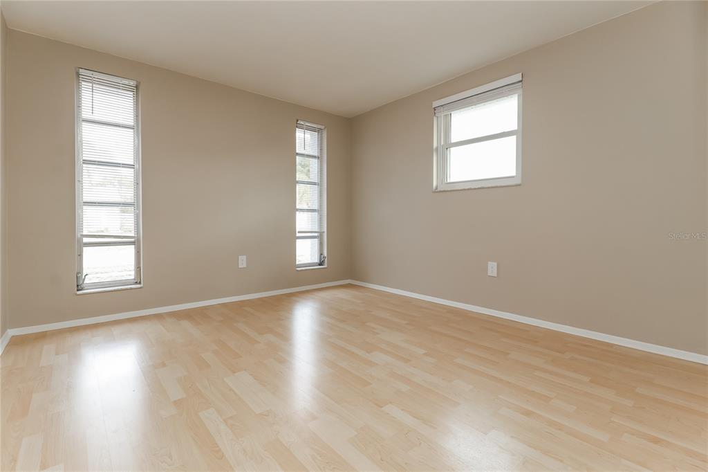 4153 Woodtrail Boulevard New Port Richey, FL 34653 - Photo 12 of 16 an empty room with wooden floor and windows
