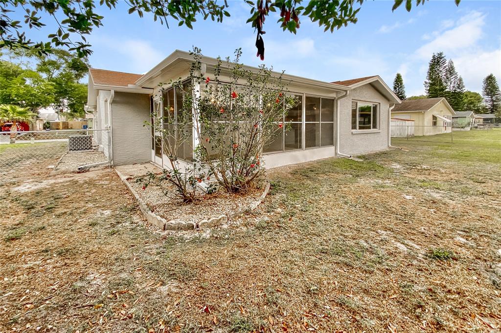 4153 Woodtrail Boulevard New Port Richey, FL 34653 - Photo 14 of 16 a front view of a house with a yard