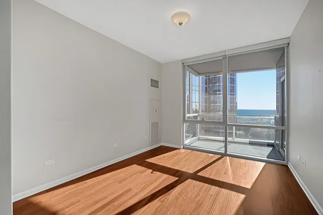 a room with a bed and glass door