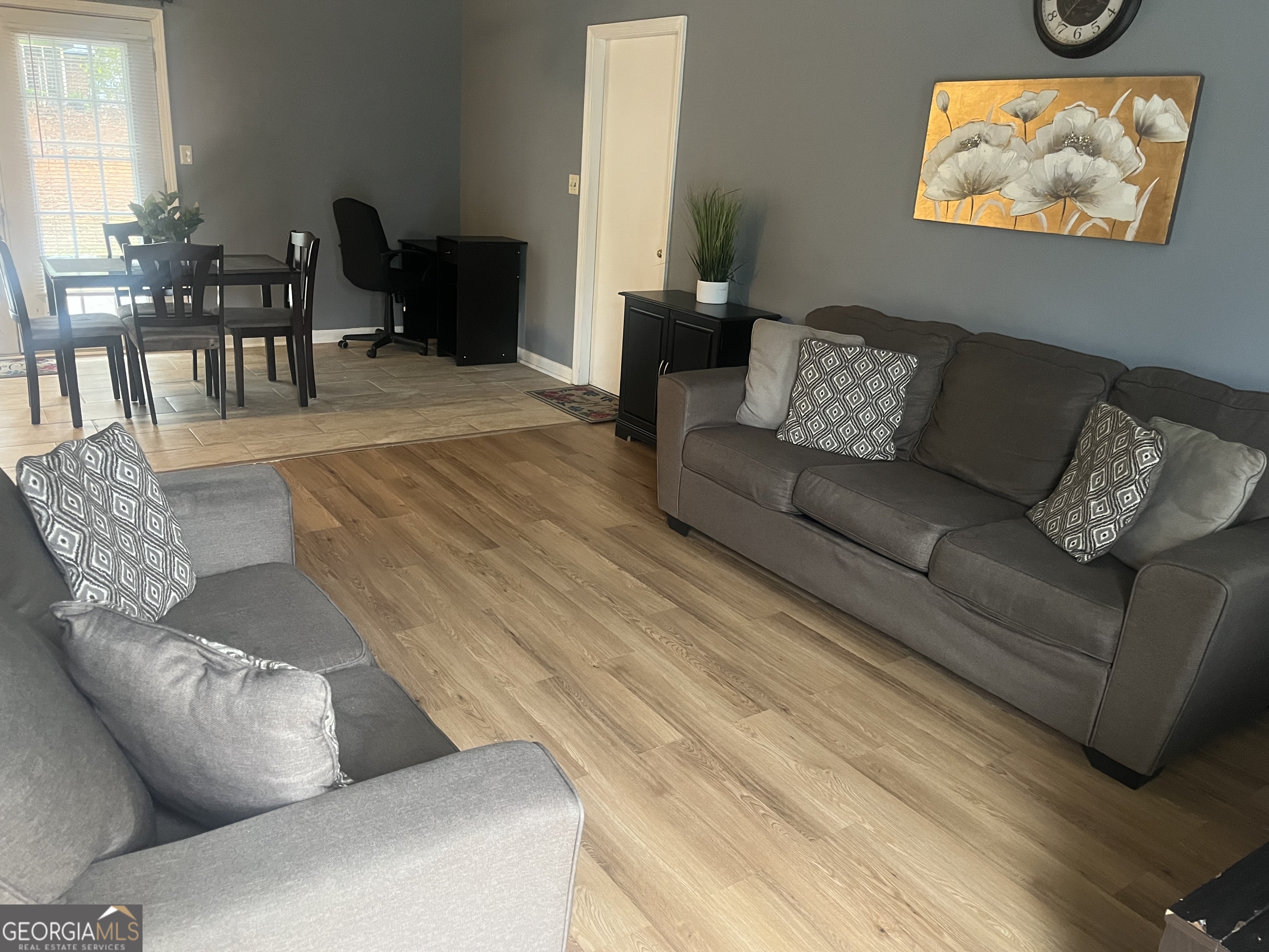 7013 Fielder Road Rex, GA 30273 - Photo 2 of 8 a living room with furniture and a dining table with wooden floor