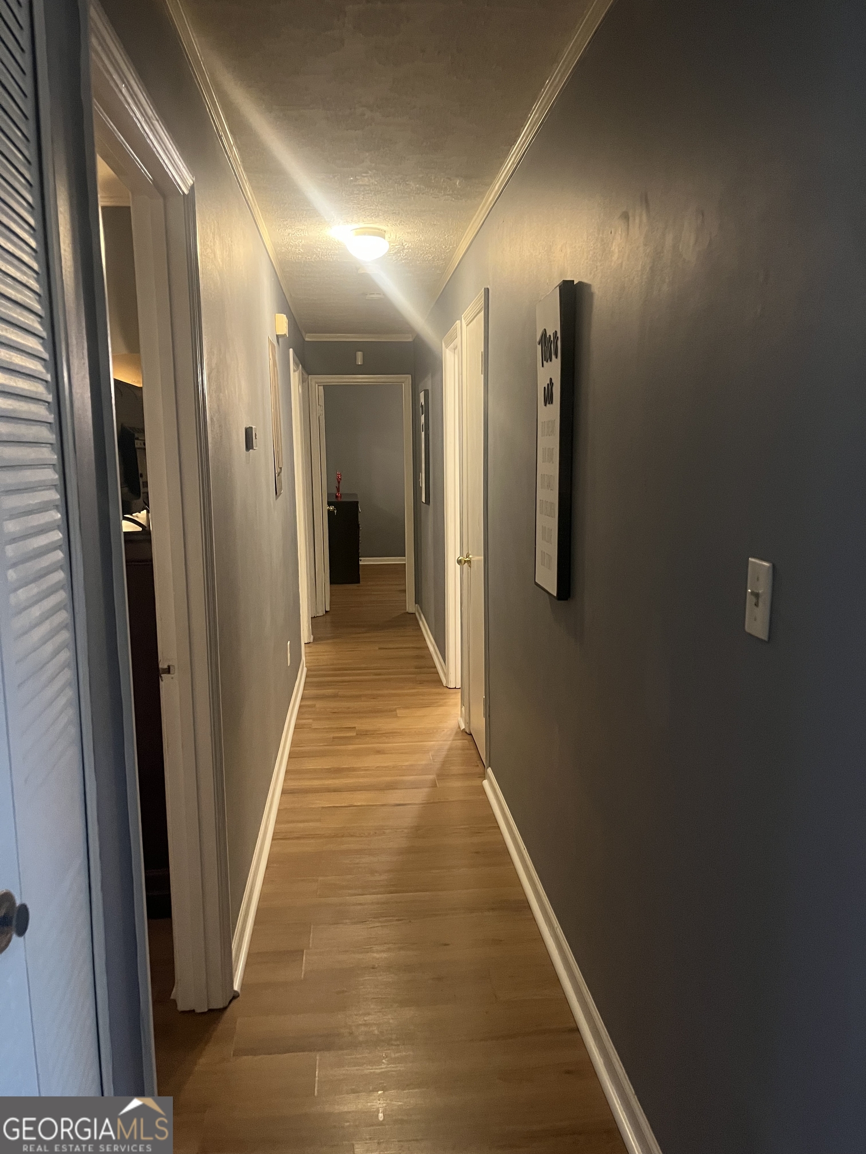 7013 Fielder Road Rex, GA 30273 - Photo 3 of 8 a view of hallway with wooden floor