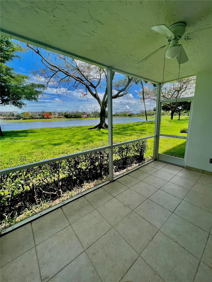 3150 North Course Lane, Unit 107 Pompano Beach, FL 33069 - Photo 1 of 24 a view of a two chair under an umbrella